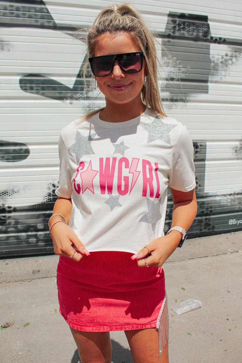 Long live cowgirls! Get the perfect look for a night out in Nashville with our Cowgirl Glitter Star Graphic Tee! This custom hand made cropped gem features sparkly stars and is guaranteed to show off your honky-tonk style. Shine bright like a diamond in the wild, wild west!