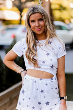 Soft lightweight white romper covered in trendy stars featuring elastic cutout waist. Perfect outfit for the 4th of July! Grey Star Cutout Side Romper - Find Cute Patriotic Outfits Online At Kendry Collection Boutique