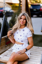 Soft lightweight white romper covered in trendy stars featuring elastic cutout waist. Perfect outfit for the 4th of July! Grey Star Cutout Side Romper - Find Cute Patriotic Outfits Online At Kendry Collection Boutique