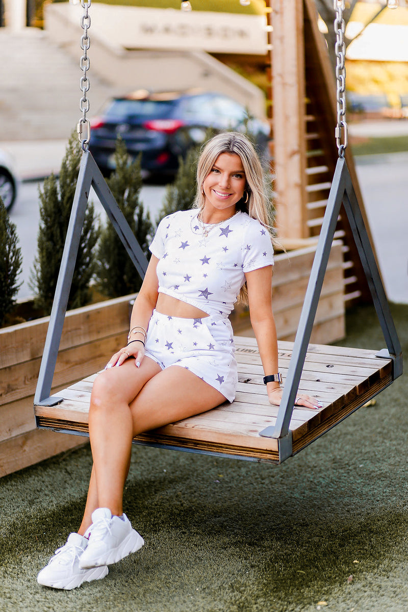 Soft lightweight white romper covered in trendy stars featuring elastic cutout waist. Perfect outfit for the 4th of July! Grey Star Cutout Side Romper - Find Cute Patriotic Outfits Online At Kendry Collection Boutique