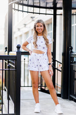 Soft lightweight white romper covered in trendy stars featuring elastic cutout waist. Perfect outfit for the 4th of July! Grey Star Cutout Side Romper - Find Cute Patriotic Outfits Online At Kendry Collection Boutique