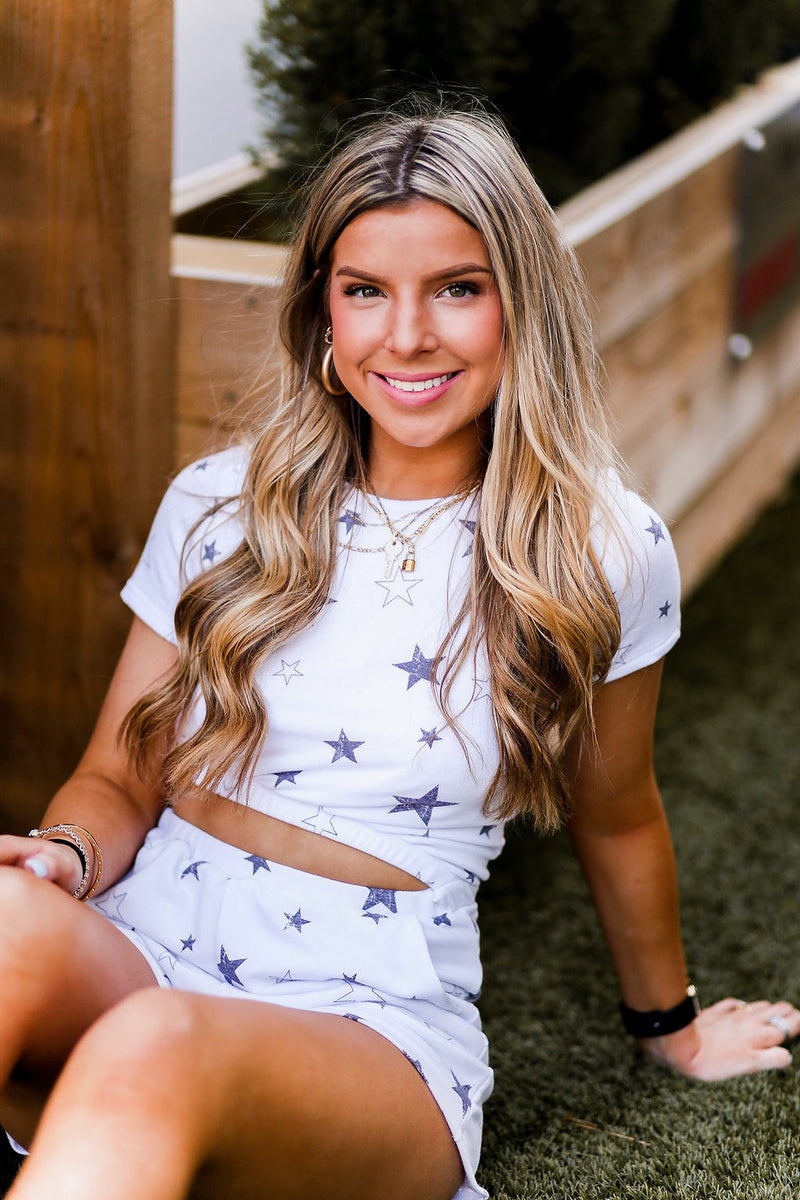 Soft lightweight white romper covered in trendy stars featuring elastic cutout waist. Perfect outfit for the 4th of July! Grey Star Cutout Side Romper - Find Cute Patriotic Outfits Online At Kendry Collection Boutique