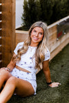 Soft lightweight white romper covered in trendy stars featuring elastic cutout waist. Perfect outfit for the 4th of July! Grey Star Cutout Side Romper - Find Cute Patriotic Outfits Online At Kendry Collection Boutique