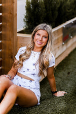 Soft lightweight white romper covered in trendy stars featuring elastic cutout waist. Perfect outfit for the 4th of July! Grey Star Cutout Side Romper - Find Cute Patriotic Outfits Online At Kendry Collection Boutique