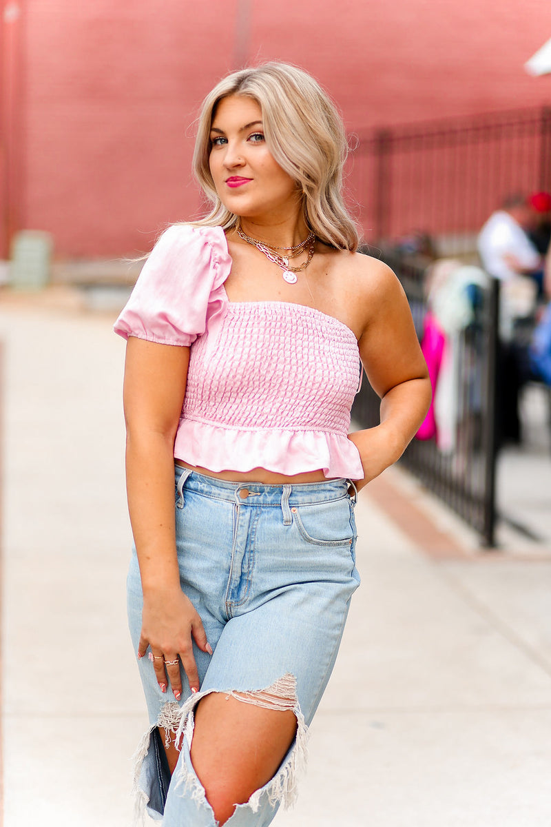 One shoulder puff sleeve smocked top featuring ruffle hem. Pair it with a trendy white skirt and you're ready to go! Pink Puff Sleeve Smocked Top - Shop Kendry Collection Boutique